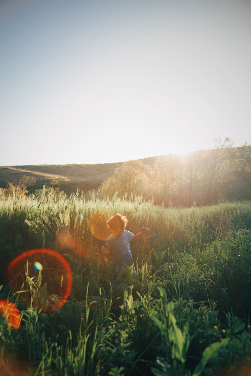 A child running through a sunlit meadow